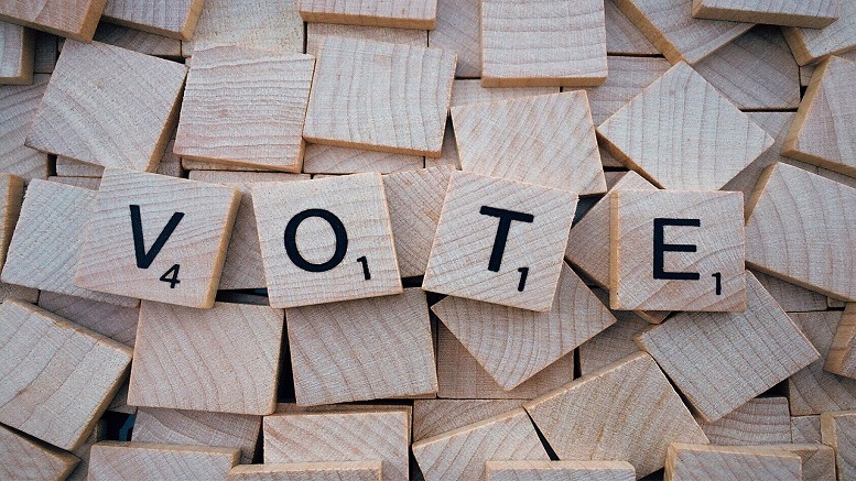 Scrabble letters to spell vote to show polling and surveys influence